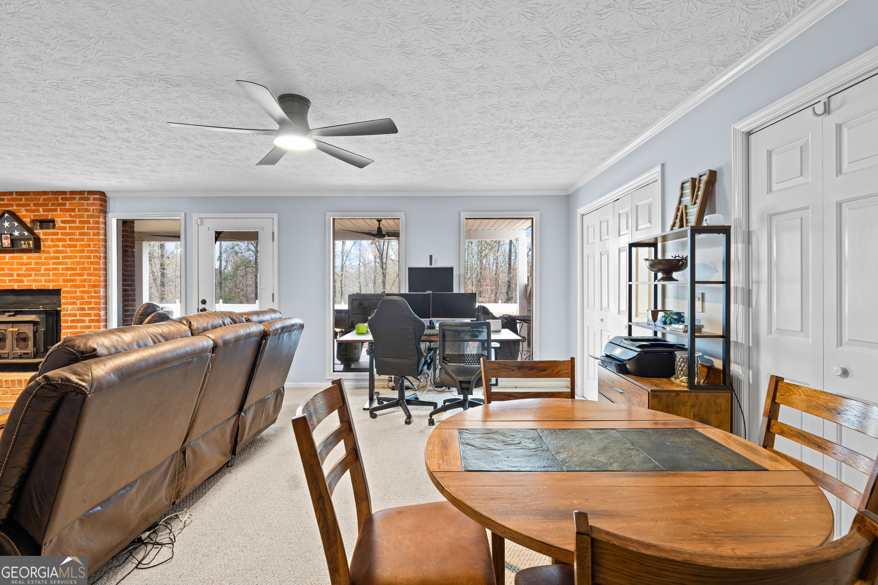 296 Ebenezer Church Road Fayetteville, GA 30215 - Photo 30 of 66 a dining room with wooden floor a chandelier fan a glass table and chairs