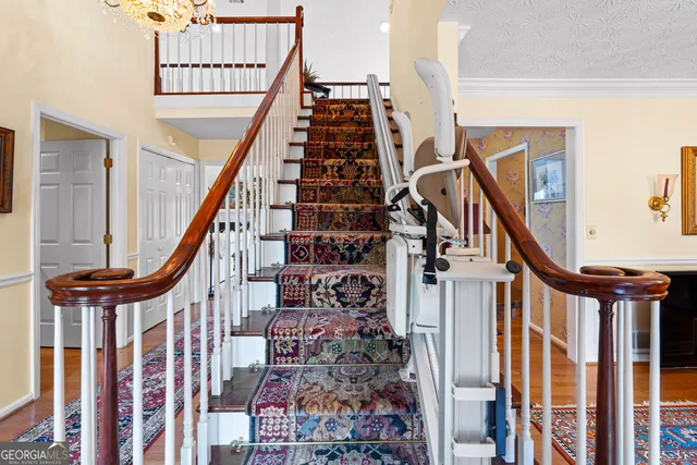 a living room with furniture a fireplace and a chandelier
