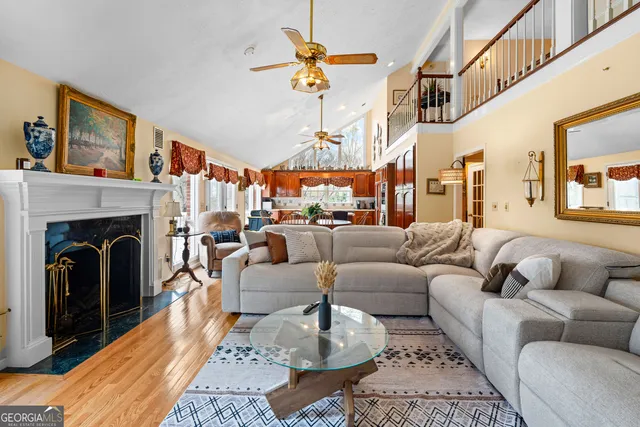 a living room with furniture a rug and a shelf