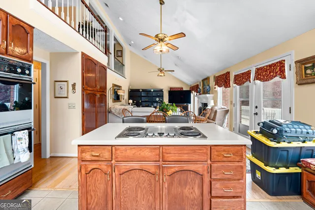 a large kitchen with stainless steel appliances granite countertop a sink and a stove