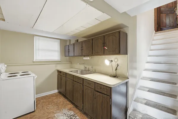 a kitchen with a sink stove and cabinets