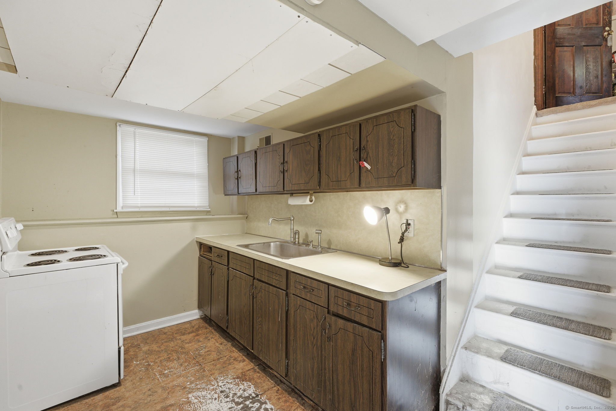 184 Putting Green Road Trumbull, CT 06611 - Photo 16 of 24 a kitchen with a sink stove and cabinets