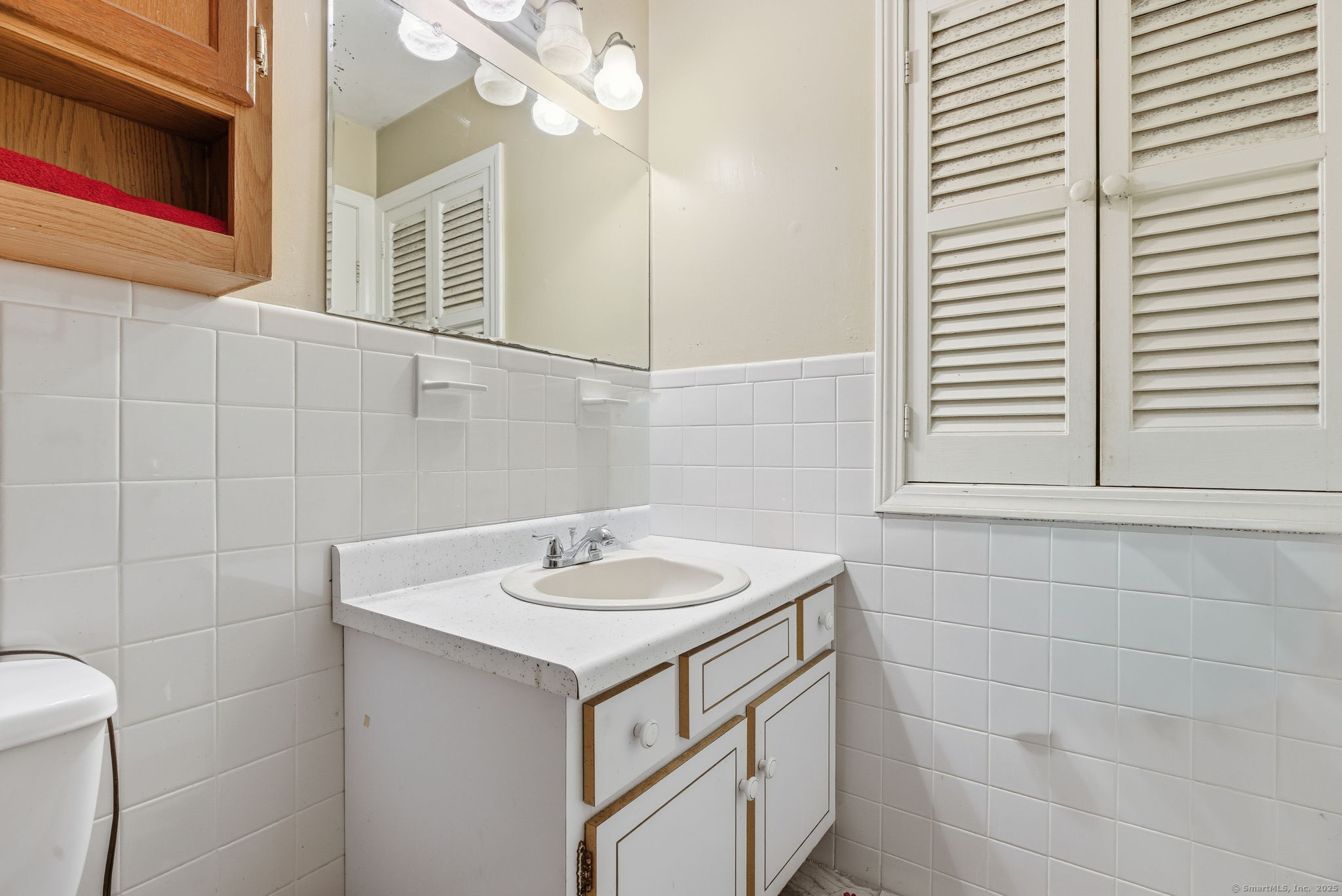 184 Putting Green Road Trumbull, CT 06611 - Photo 6 of 24 a bathroom with a sink and a mirror