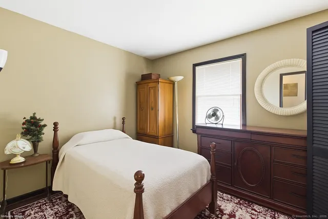 a bedroom with a bed and a dresser