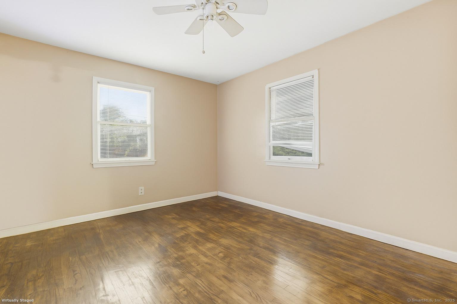 184 Putting Green Road Trumbull, CT 06611 - Photo 9 of 24 a view of an empty room with wooden floor and a window