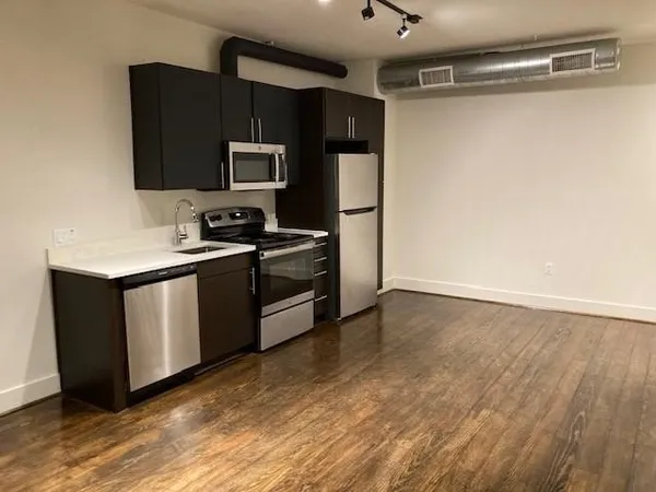 a kitchen with stainless steel appliances a refrigerator and a microwave