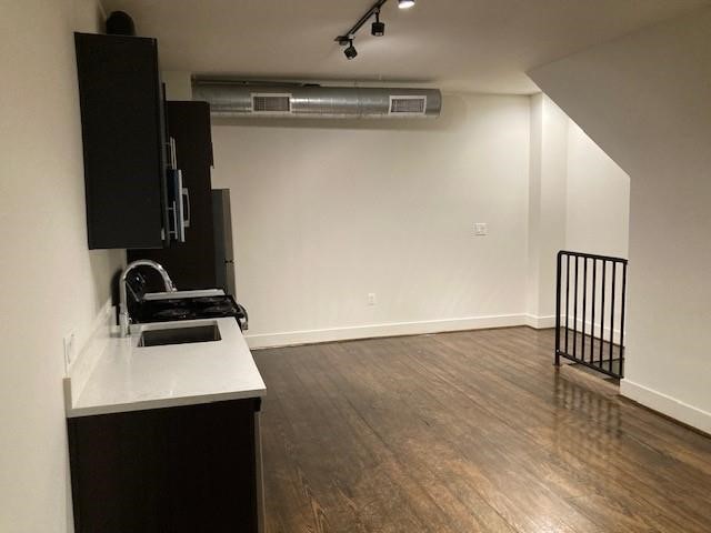 4411 Dallas Street, Unit 44 Houston, TX 77023 - Photo 11 of 16 a room with wooden floor and cabinets
