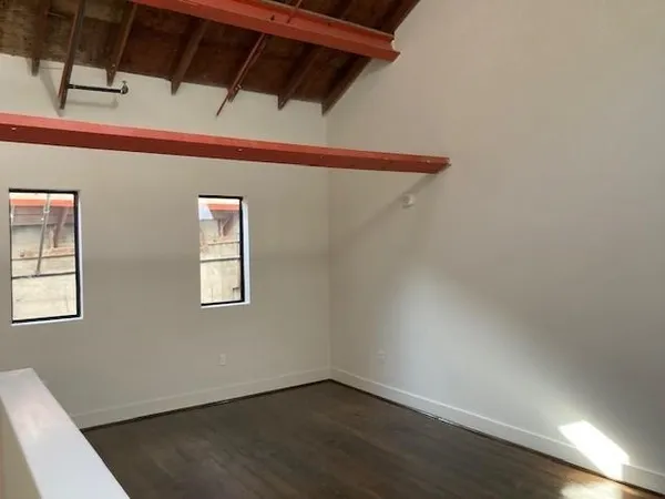 a view of a room with wooden floor and windows