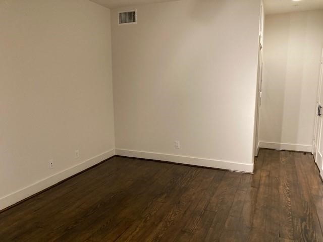 4411 Dallas Street, Unit 44 Houston, TX 77023 - Photo 5 of 16 a view of an empty room with wooden floor