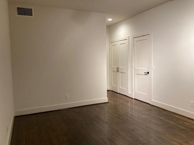 4411 Dallas Street, Unit 44 Houston, TX 77023 - Photo 6 of 16 an empty room with wooden floor and closet area