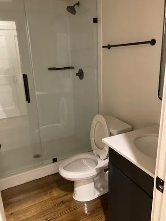 a white toilet sitting next to a bathroom sink