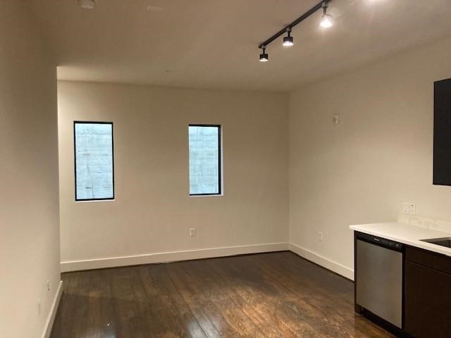 4411 Dallas Street, Unit 44 Houston, TX 77023 - Photo 9 of 16 an empty room with wooden floor and windows