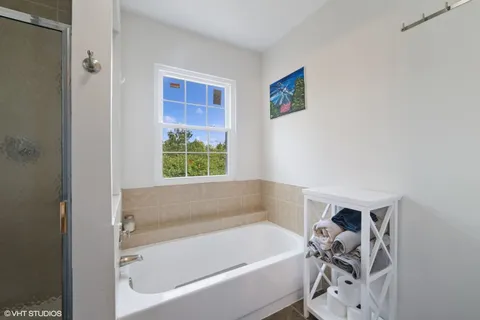 a bathroom with a bathtub and a window