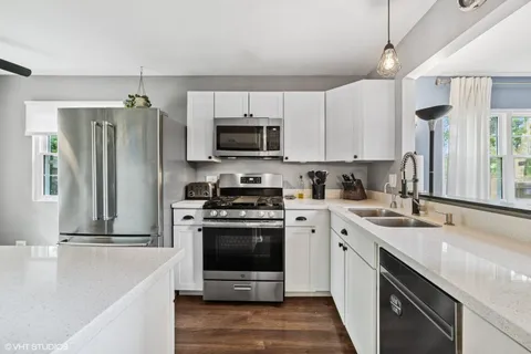 a kitchen with a sink stove and refrigerator