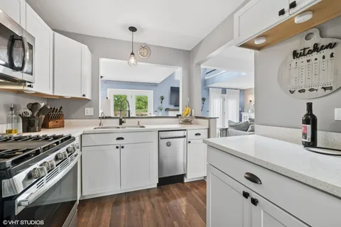 a kitchen with a sink cabinets and window