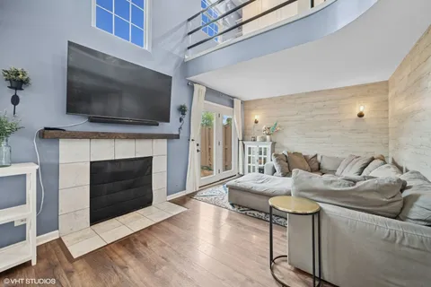 a living room with furniture a flat screen tv and a fireplace