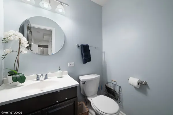 a bathroom with a toilet a sink and mirror