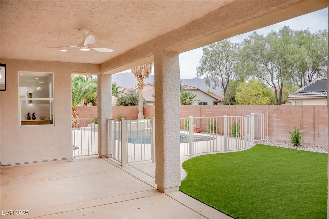 7870 Midnight Ride Street Las Vegas, NV 89131 - Photo 53 of 69 Fenced backyard featuring a patio area and ceiling fan