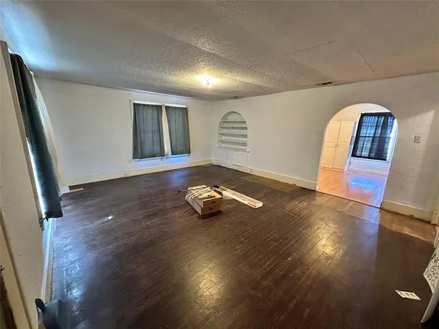 a room with hard wood floors and a window
