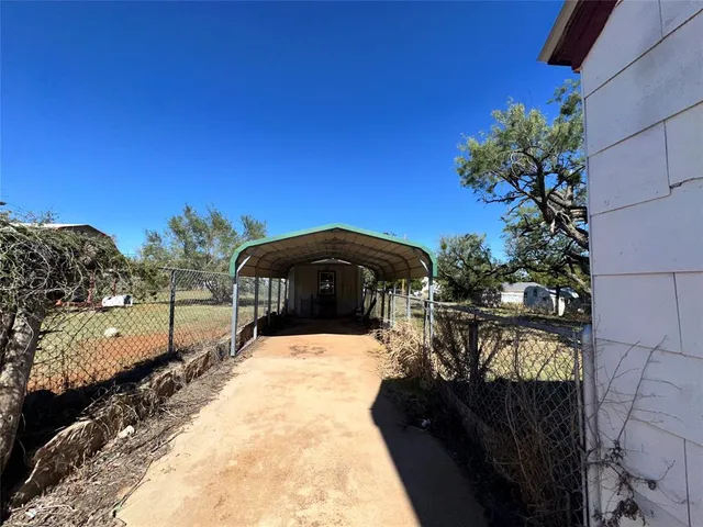 a view of a yard with a lot of flower plants