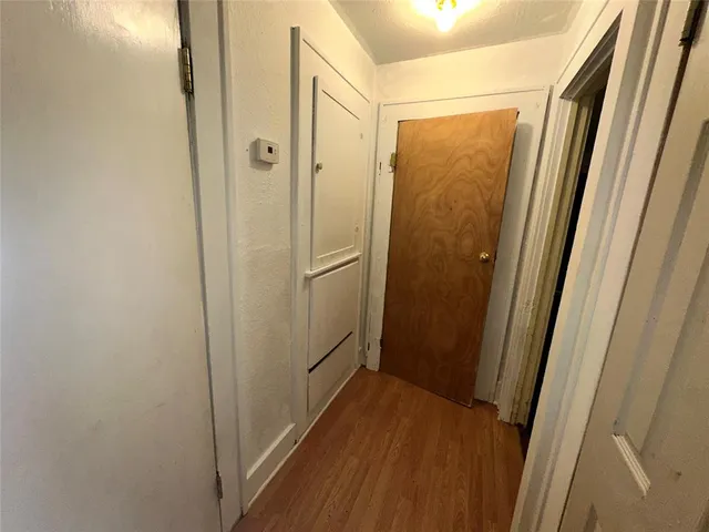 a bathroom with a glass door shower and closet