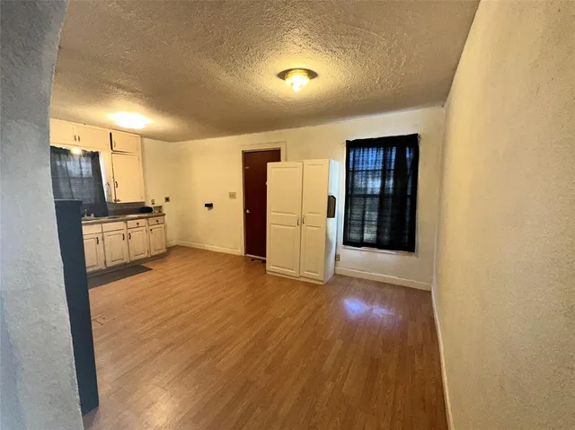 a view of a kitchen with a sink and a refrigerator