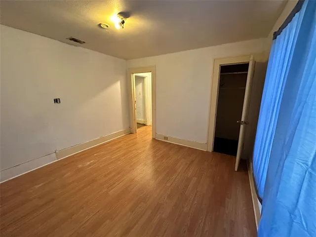 a view of hallway with wooden floor