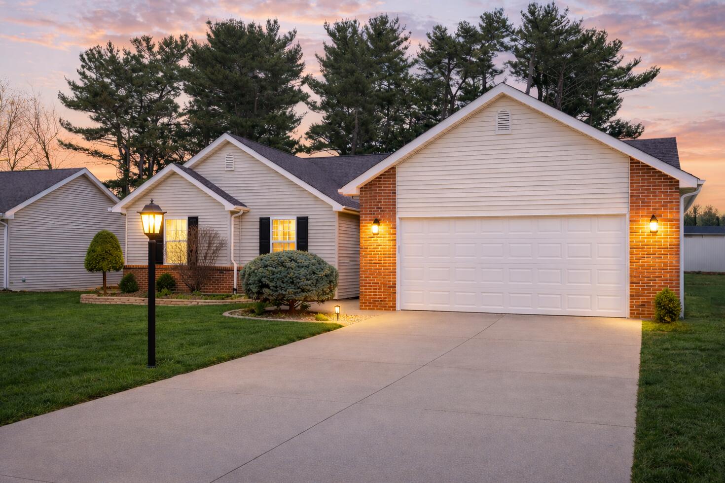 a view of house with a yard and potted plants