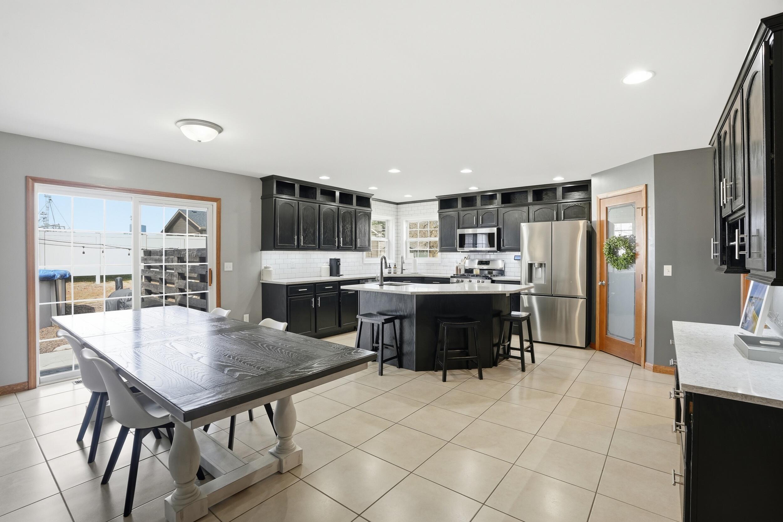 414 17th Street Southeast De Motte, IN 46310 - Photo 3 of 26 a kitchen with kitchen island a sink stove and refrigerator