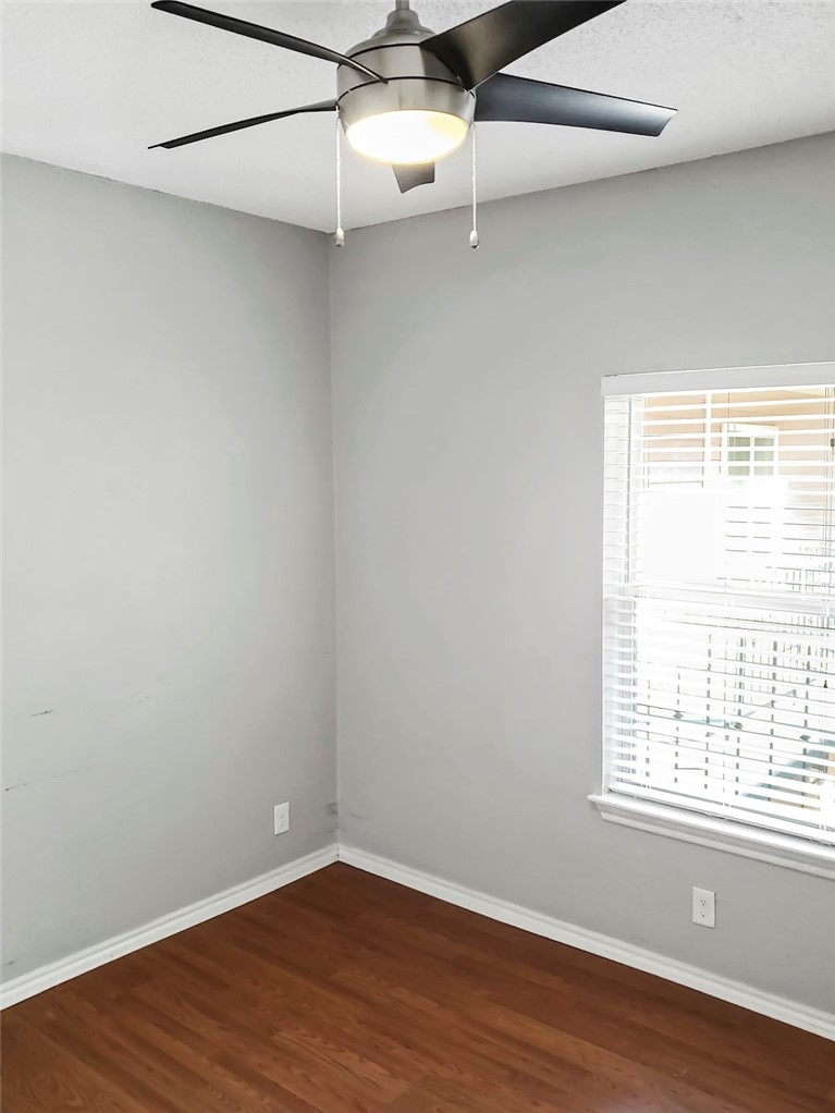 2414 Longview Street, Unit 206 Austin, TX 78705 - Photo 12 of 17 an empty room with wooden floor and windows