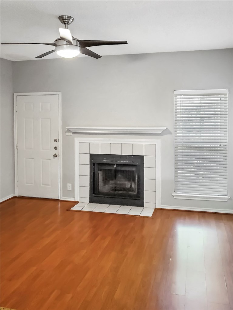 2414 Longview Street, Unit 206 Austin, TX 78705 - Photo 2 of 17 a view of empty room with wooden floor and fireplace
