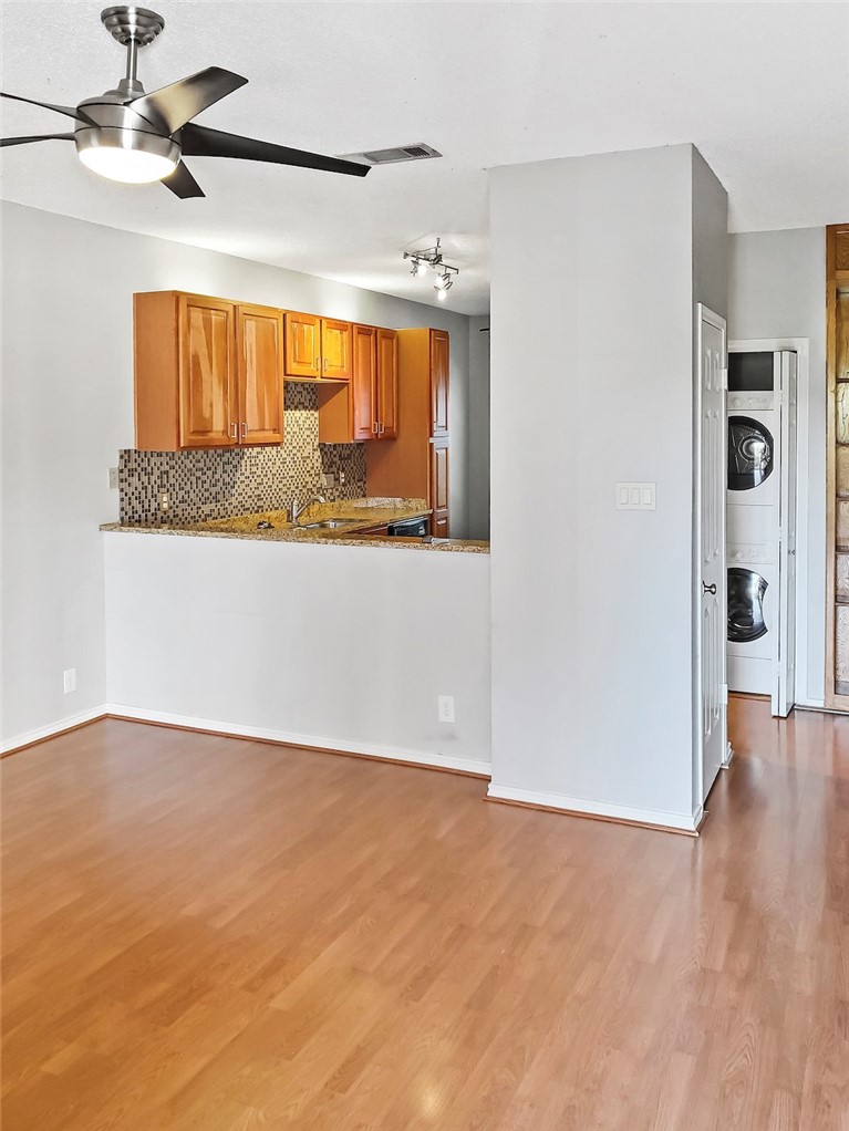 2414 Longview Street, Unit 206 Austin, TX 78705 - Photo 3 of 17 a view of a kitchen with a sink and wooden floor