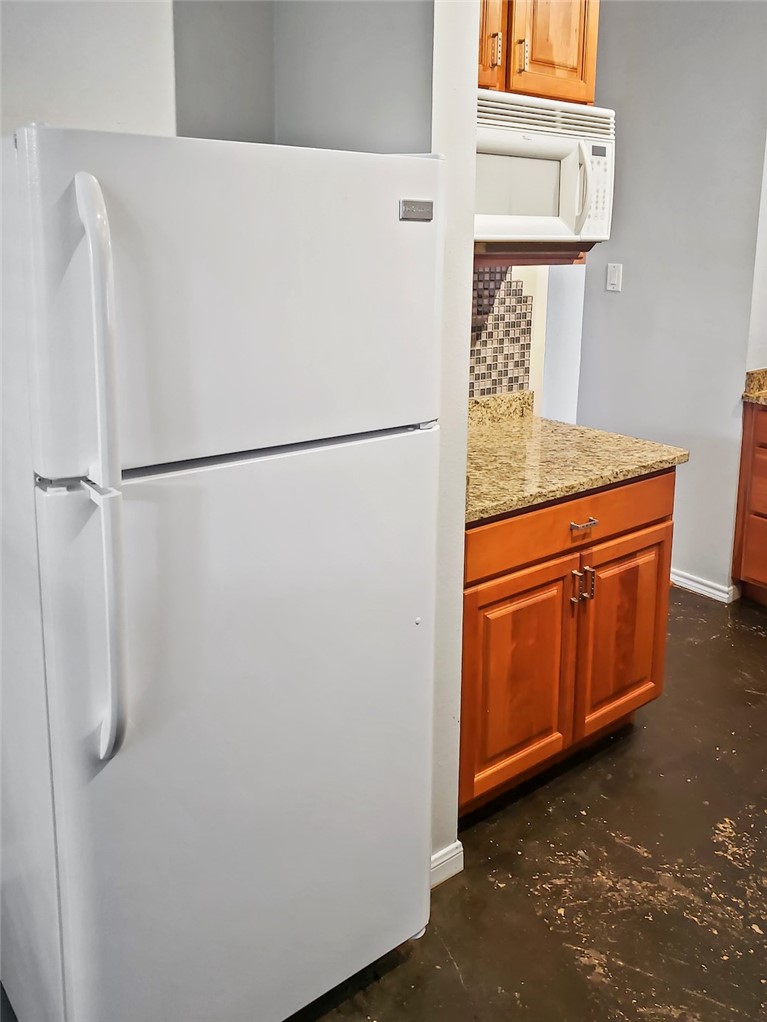 2414 Longview Street, Unit 206 Austin, TX 78705 - Photo 5 of 17 a white refrigerator freezer sitting inside of a kitchen