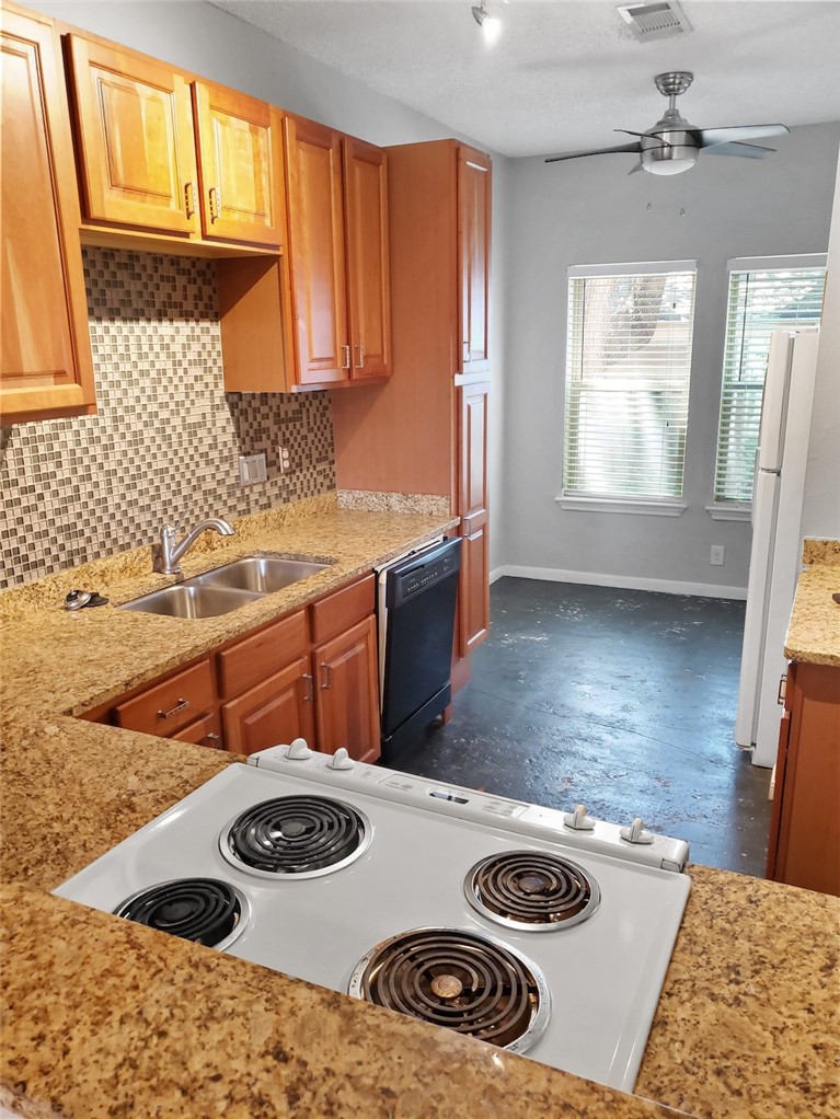 2414 Longview Street, Unit 206 Austin, TX 78705 - Photo 6 of 17 a kitchen with a stove a sink and a microwave