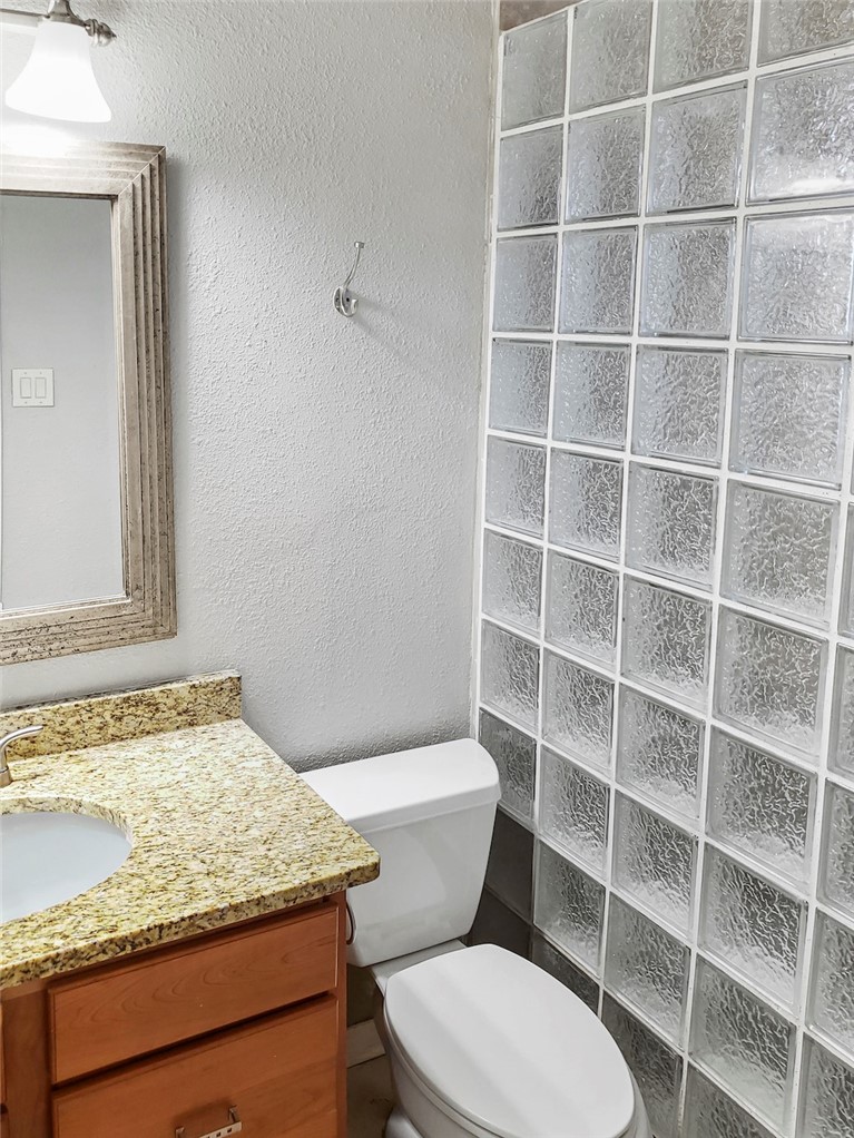 2414 Longview Street, Unit 206 Austin, TX 78705 - Photo 10 of 17 a bathroom with a granite countertop toilet sink and shower