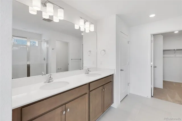a bathroom with a sink double vanity and a mirror