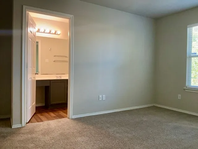 an empty room with a fireplace and window