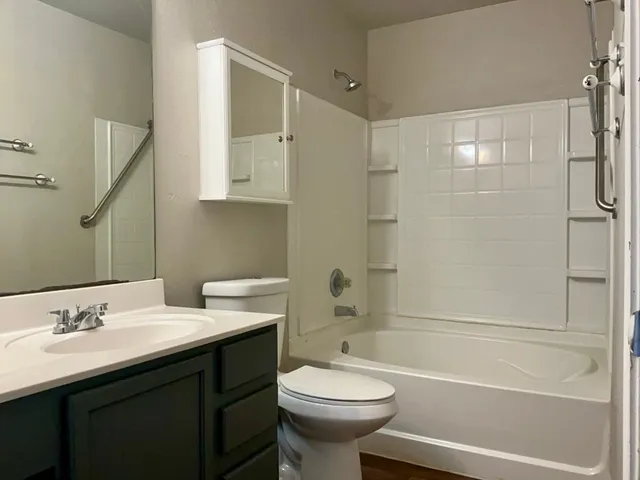 a bathroom with a sink toilet tub and shower