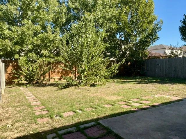 a view of yard with swimming pool