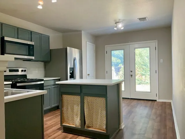 a kitchen with a stove a sink and a microwave