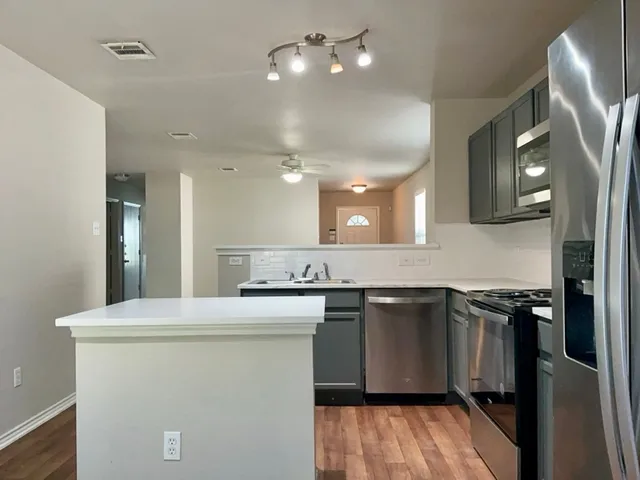 a kitchen with a sink and cabinets