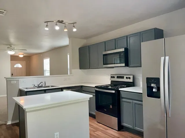 a kitchen that has a sink and a stove top oven