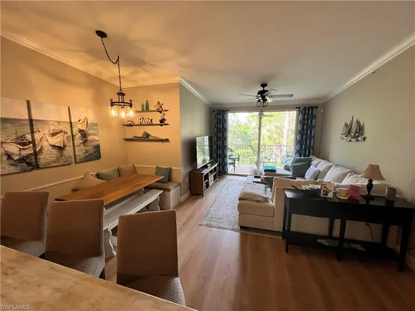 a living room with furniture a window and a chandelier