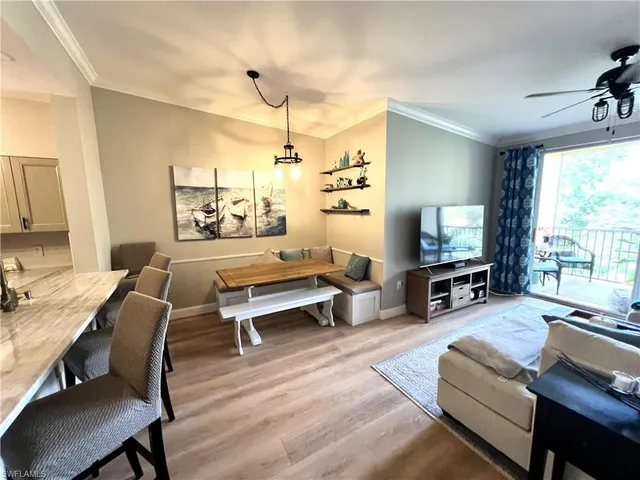 a living room with furniture a large window and a flat screen tv