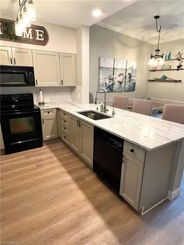 a kitchen with a sink stove and cabinets