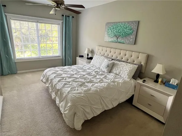 a bed sitting in a bedroom next to a window
