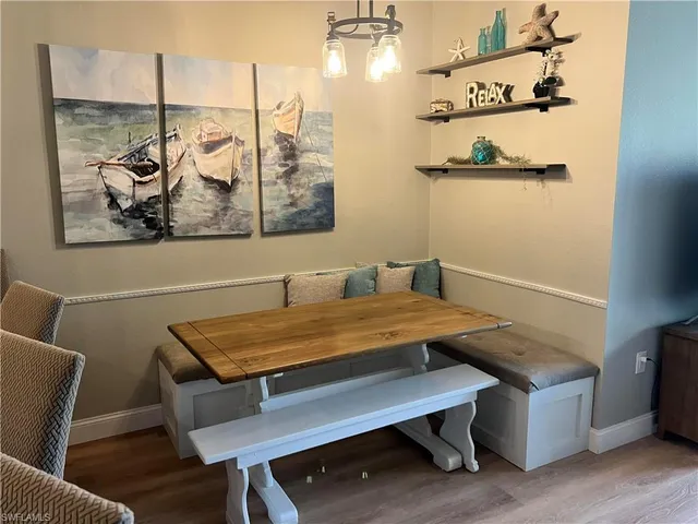 a view of a room with furniture and wooden floor