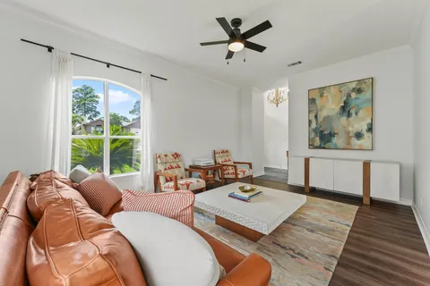 a living room with furniture fireplace and a large window