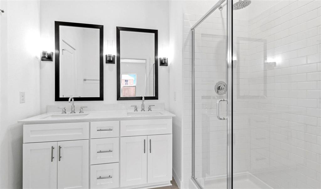 605 Ridgewood Drive Van Alstyne, TX 75495 - Photo 4 of 7 a bathroom with double sink and a mirror