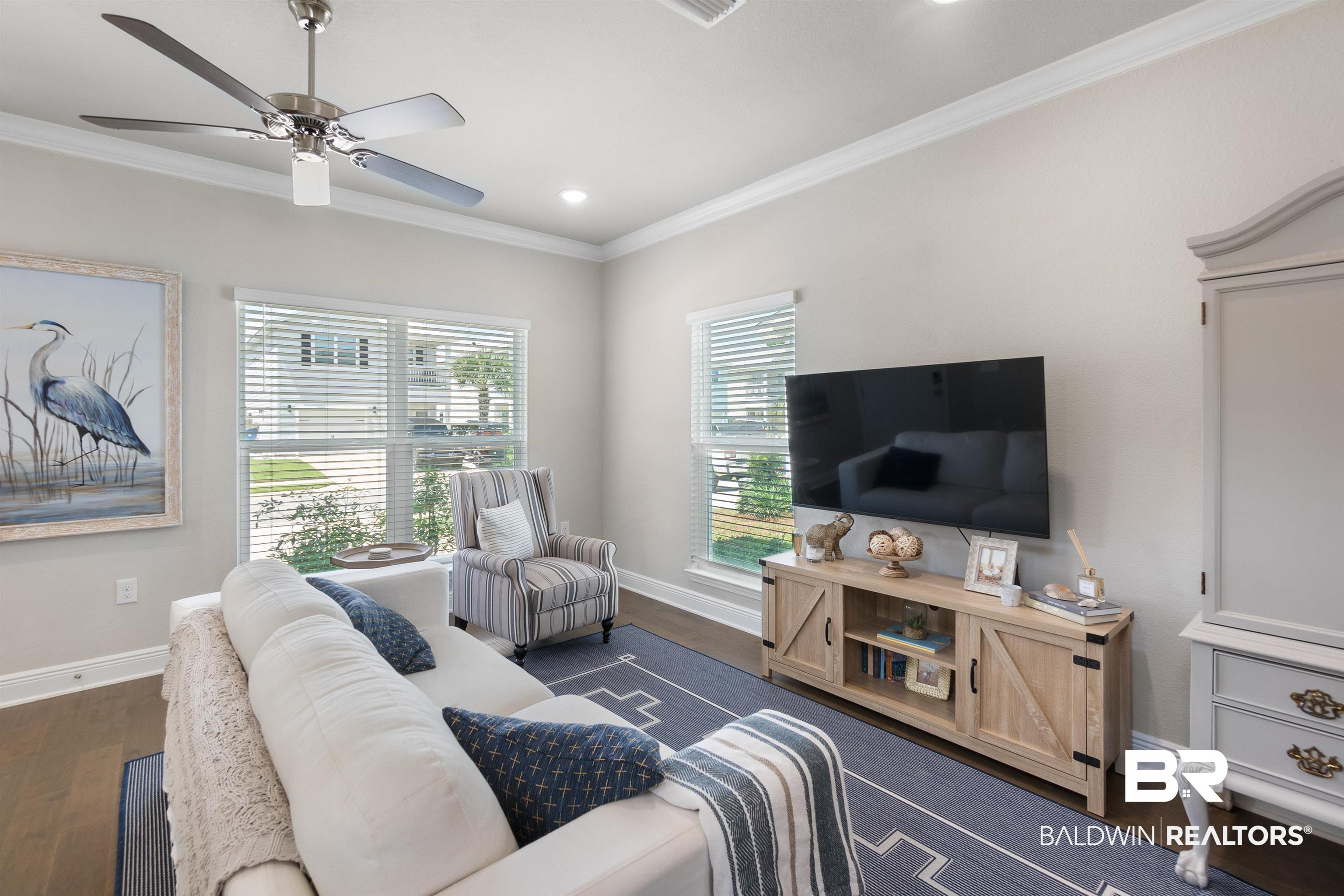 23975 Cottage Loop Orange Beach, AL 36561 - Photo 4 of 23 Living room with ceiling fan, crown molding, and dark wood-type flooring
